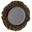 A cup of reddish-brown hojicha seen from above, ringed by roasted hojicha leaves on a white background